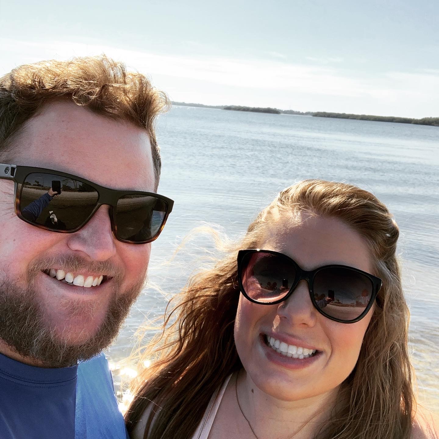 Cole and Katie Brantley smiling together by the water