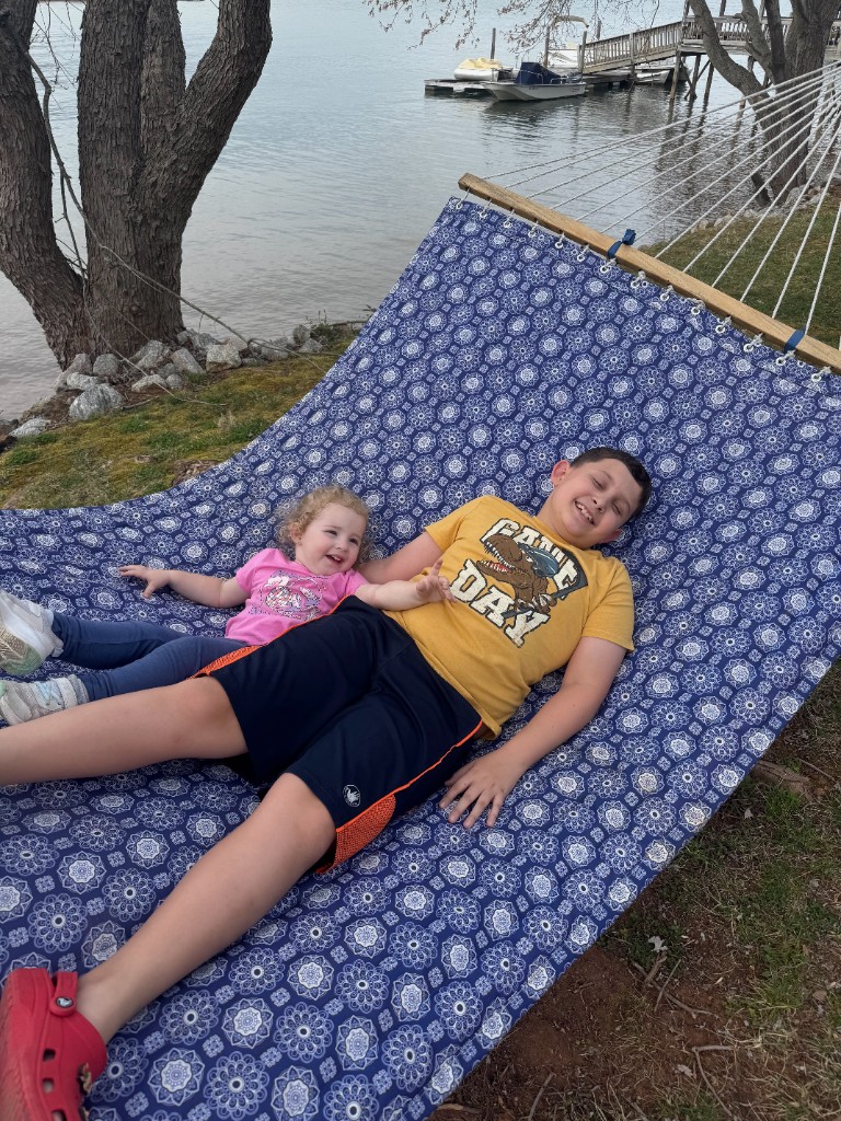 Carter and Collins Brantley relaxing on a hammock by the lake